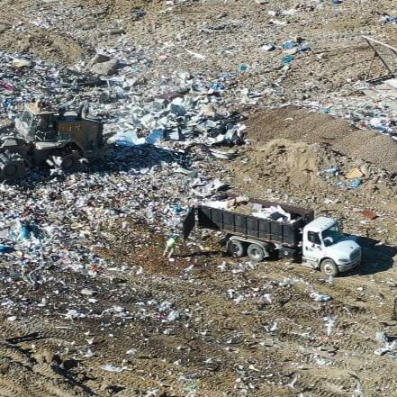 Trucks driving in landfill